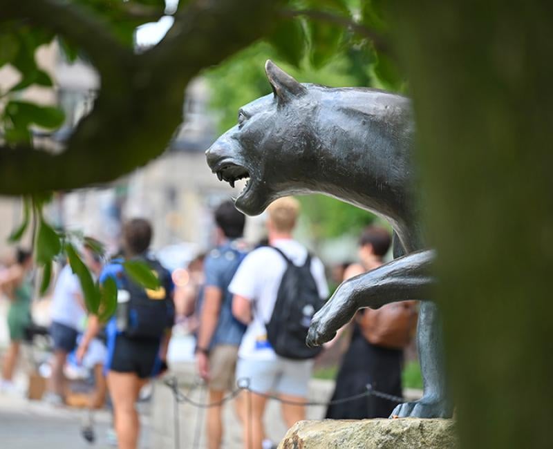 People walk past a panther statue on 51ƷƵ's campus
